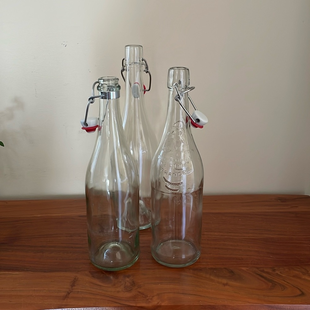 Bundle of three glass bottles with stoppers